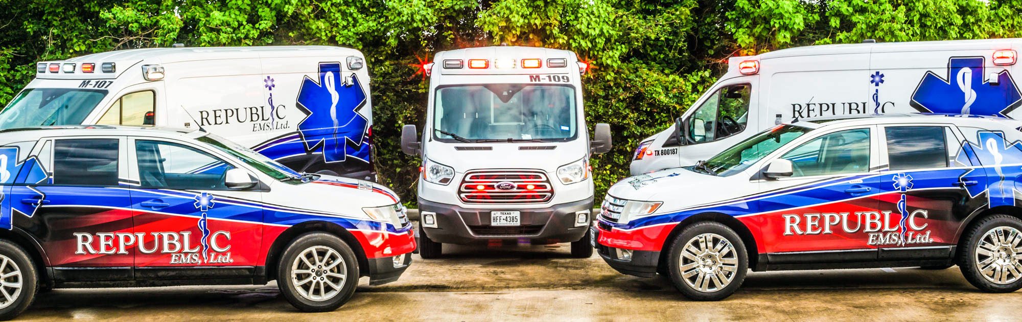 Republic EMS fleet — two ambulances and two branded SUVs lined up ready for deployment